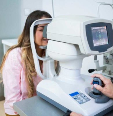 Optometrists performing eye exams on patients in a clinic