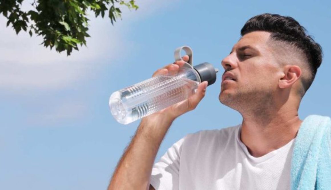 Illustration of a person staying cool under a shaded tree on a sunny day, how to prevent heat stroke