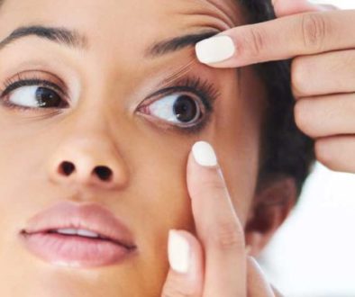 A person holding a soft contact lens, demonstrating proper soft contact lens fitting.